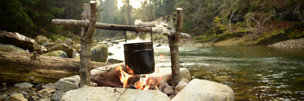cooking food in pot over campfire outdoor cooking food in pot over campfire outdoor
